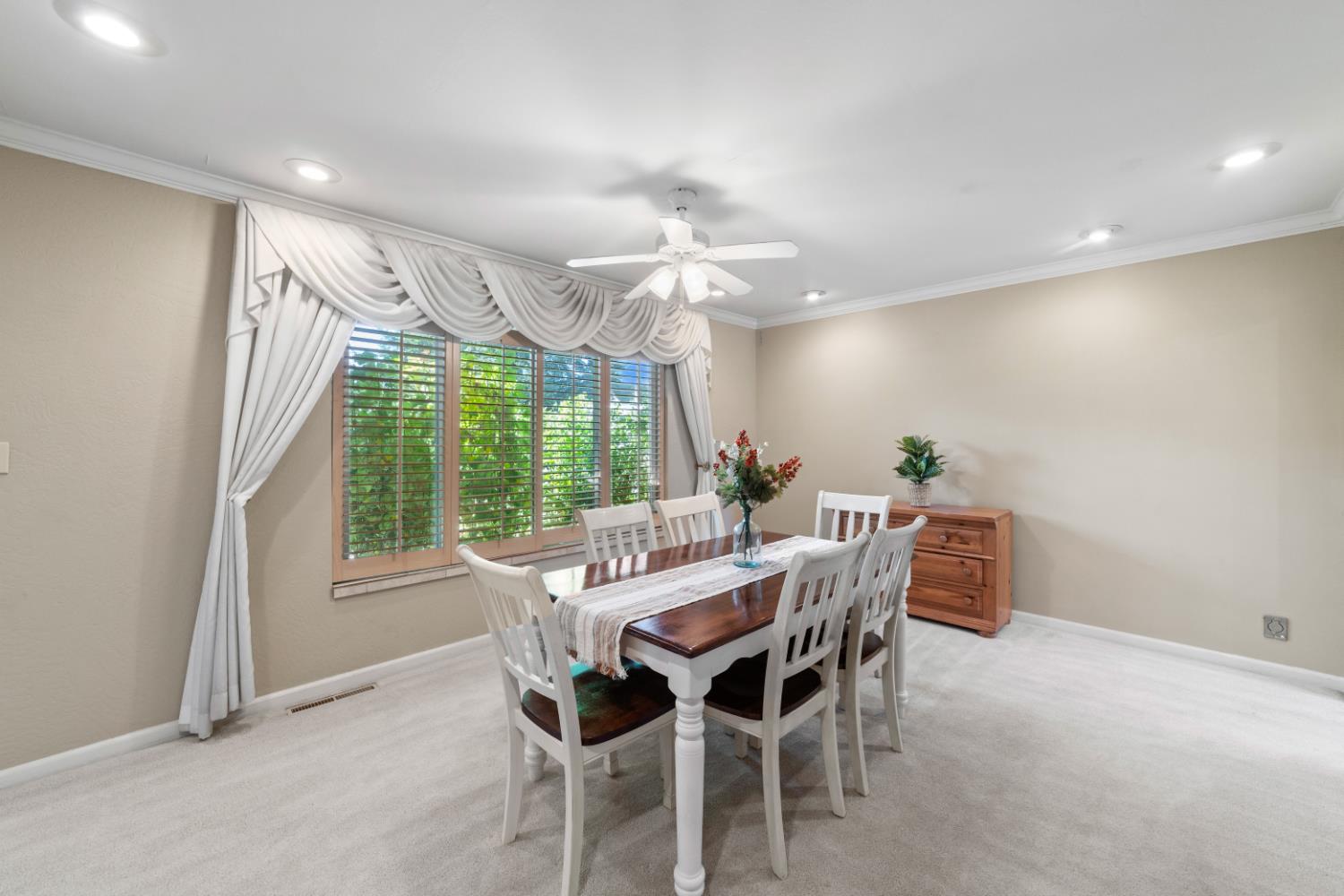 1880 Magnolia Street Gridley, CA 95948 - Photo 24 of 95 a view of a dining room with furniture a chandelier and large windows