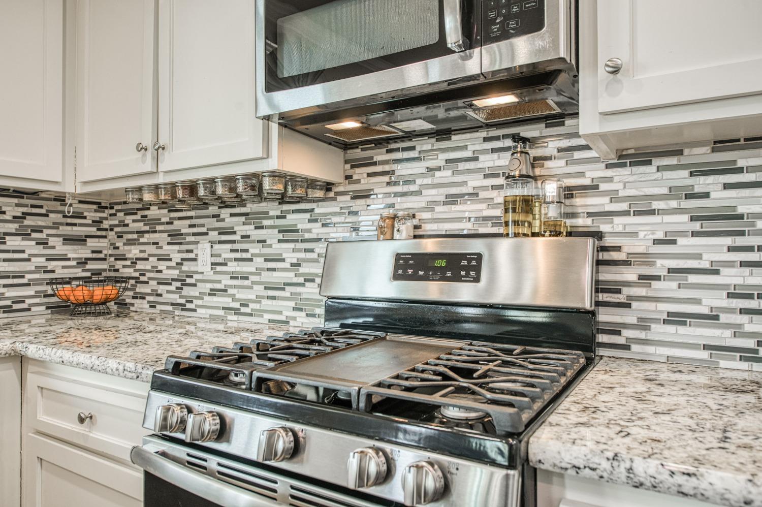 36919 Ave 17 1/2 Madera, CA 93636 - Photo 17 of 77 a stove top oven sitting inside of a kitchen