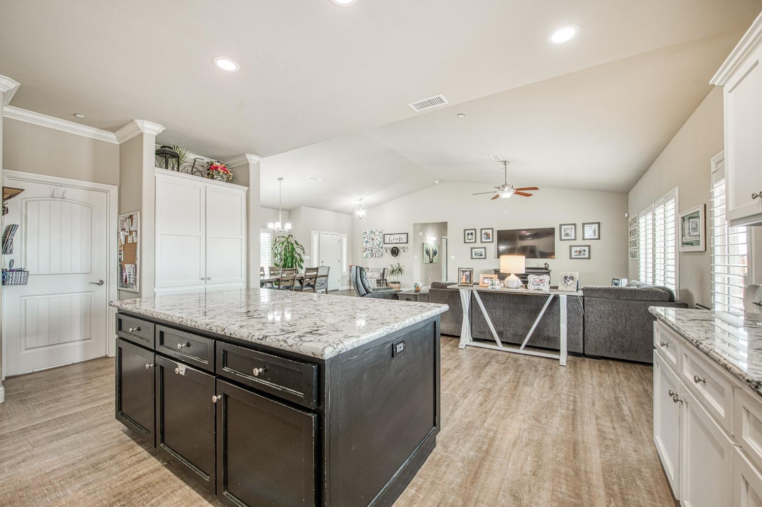 36919 Ave 17 1/2 Madera, CA 93636 - Photo 19 of 77 a kitchen with stainless steel appliances granite countertop a lot of counter space and wooden floors