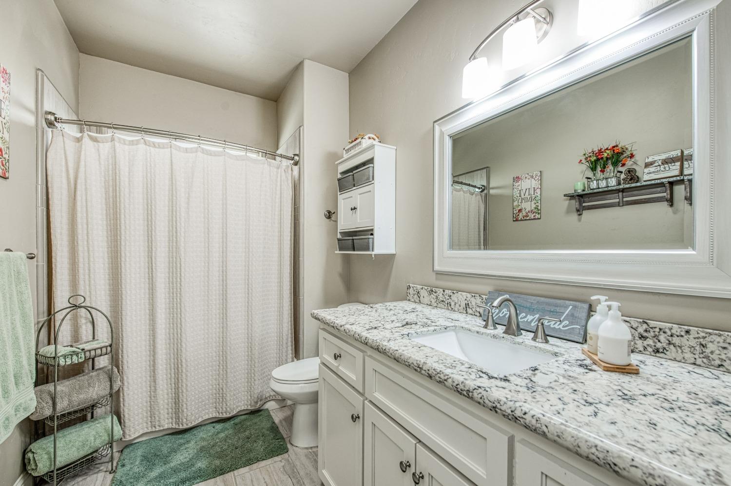 36919 Ave 17 1/2 Madera, CA 93636 - Photo 20 of 77 a bathroom with a granite countertop sink and a mirror