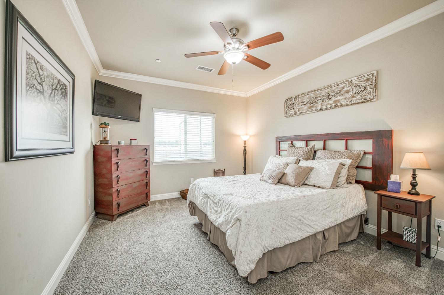 36919 Ave 17 1/2 Madera, CA 93636 - Photo 22 of 77 a bedroom with a bed dresser and window