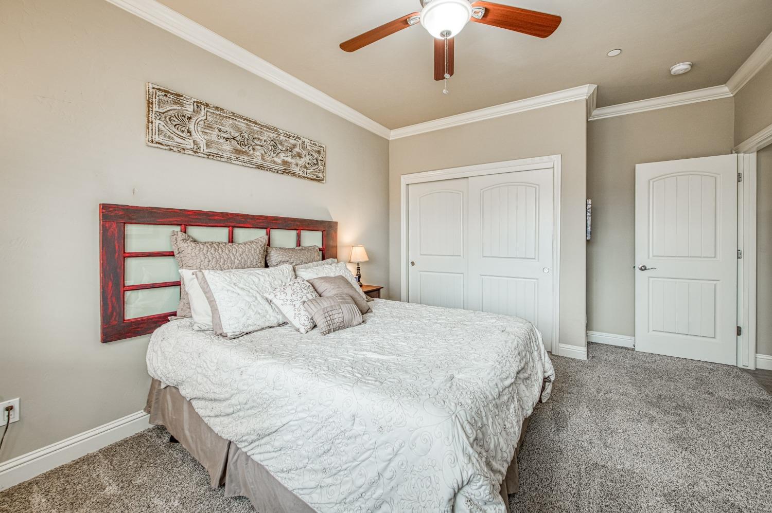 36919 Ave 17 1/2 Madera, CA 93636 - Photo 23 of 77 a bedroom with a large bed and a chandelier