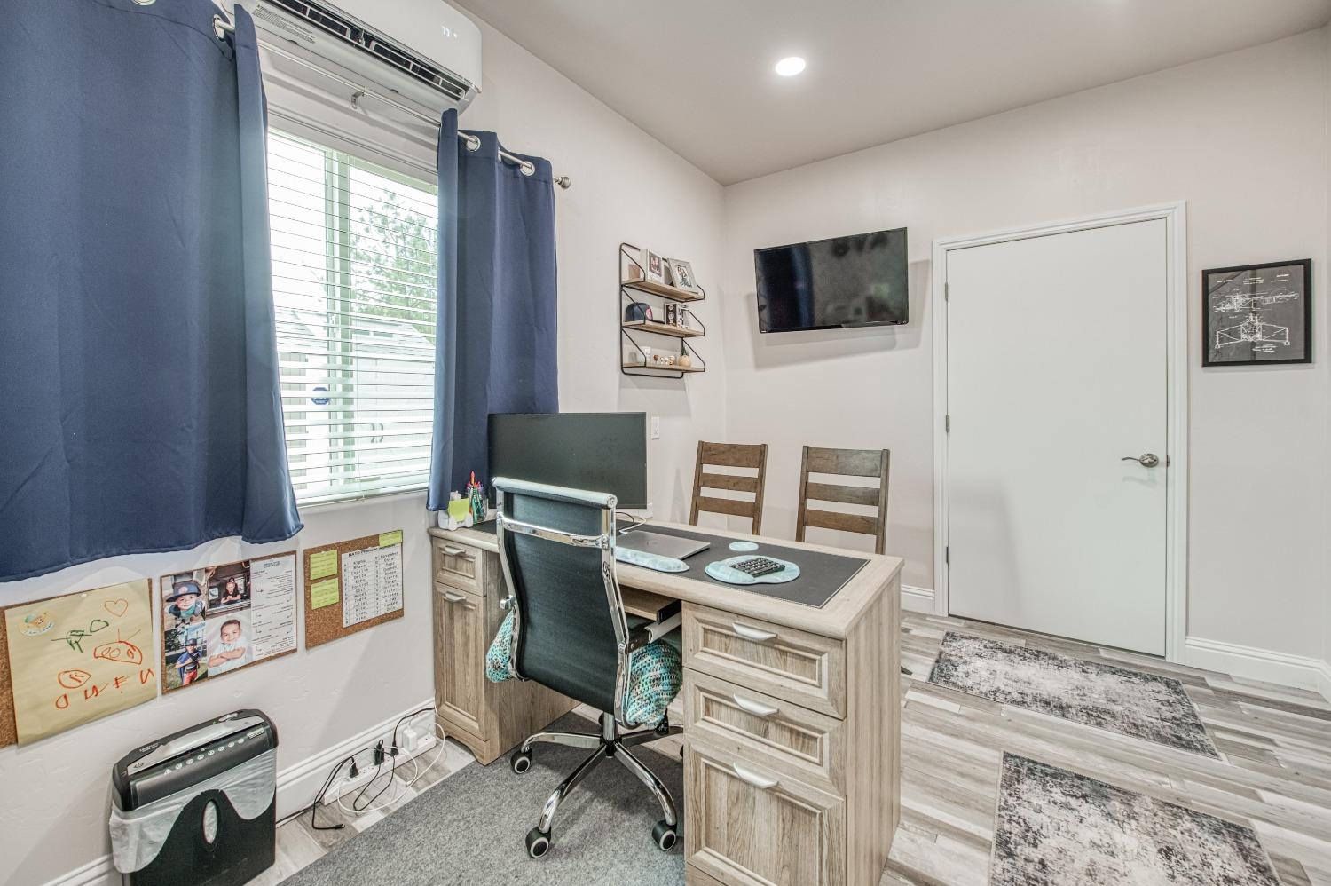 36919 Ave 17 1/2 Madera, CA 93636 - Photo 26 of 77 a view of a workspace with furniture and a window