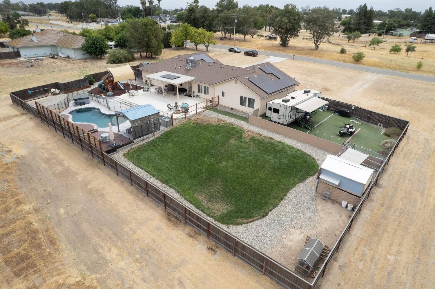36919 Ave 17 1/2 Madera, CA 93636 - Photo 3 of 77 an aerial view of a house with a garden and lake view