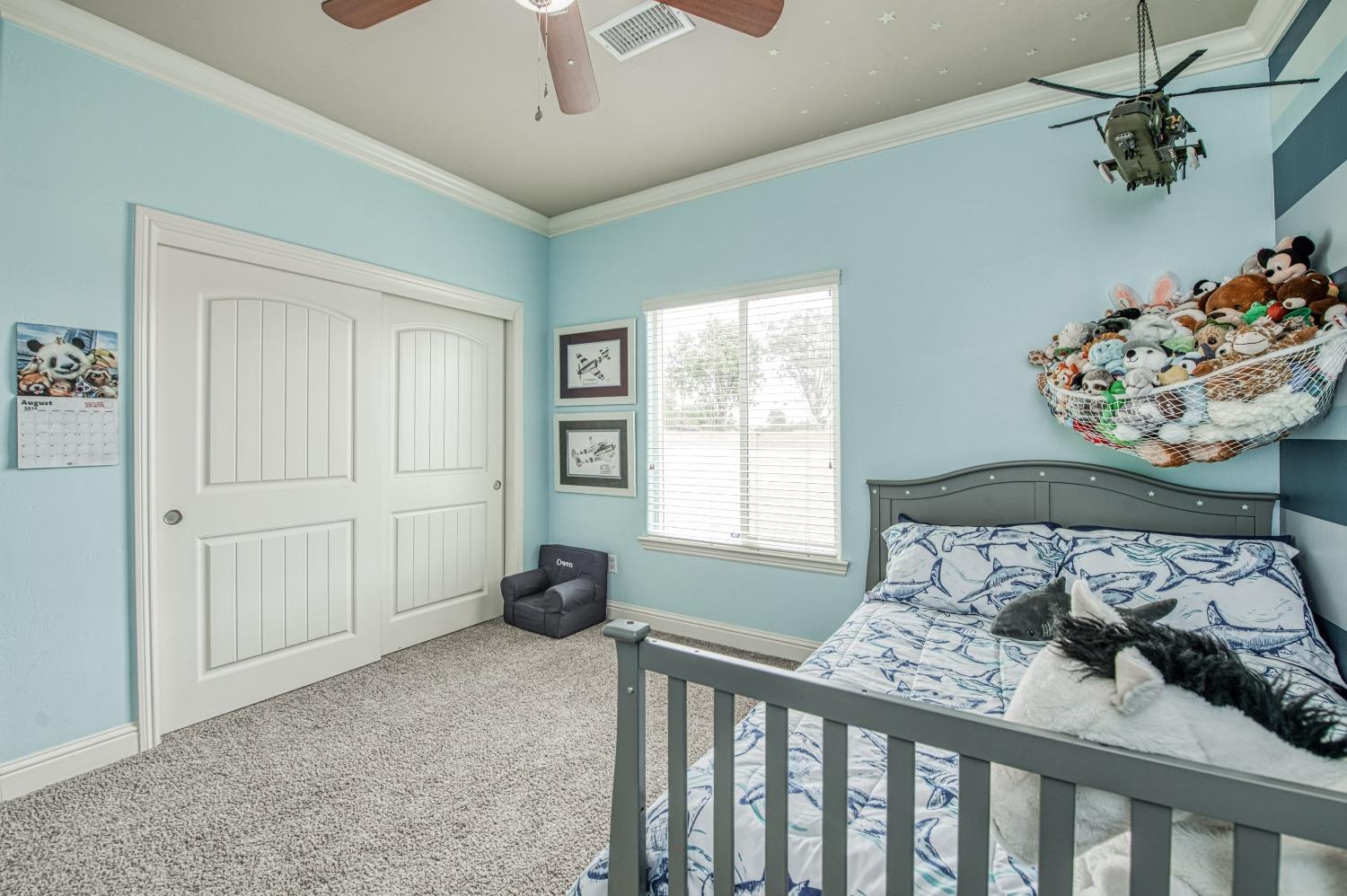 36919 Ave 17 1/2 Madera, CA 93636 - Photo 31 of 77 a bedroom with a bed and a window