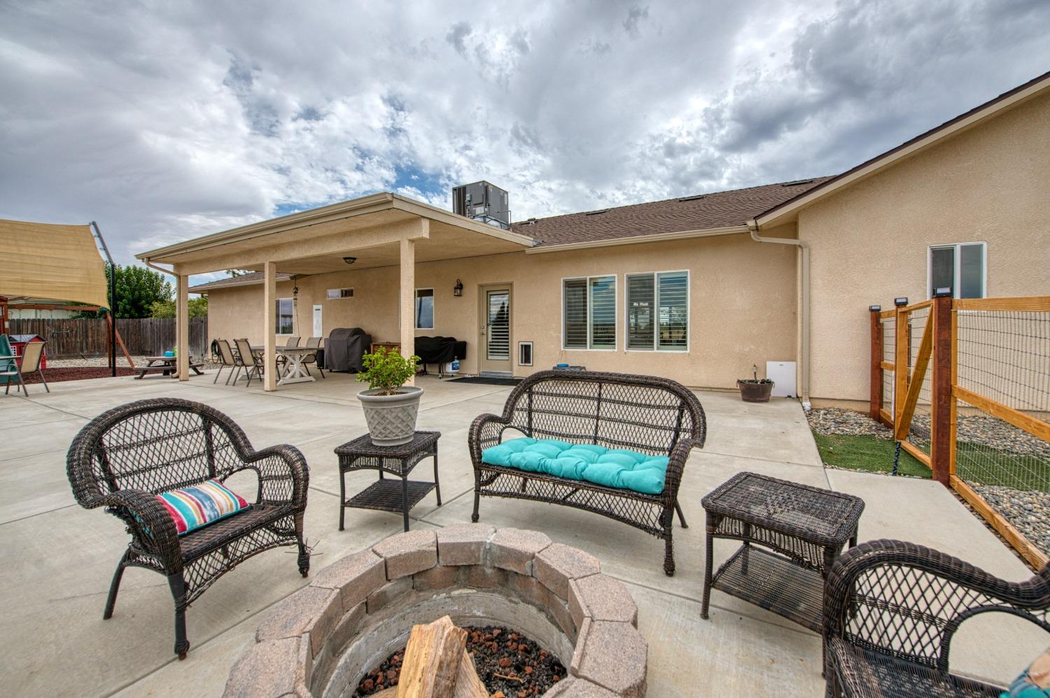 36919 Ave 17 1/2 Madera, CA 93636 - Photo 36 of 77 a view of a patio with couches table and chairs and potted plants