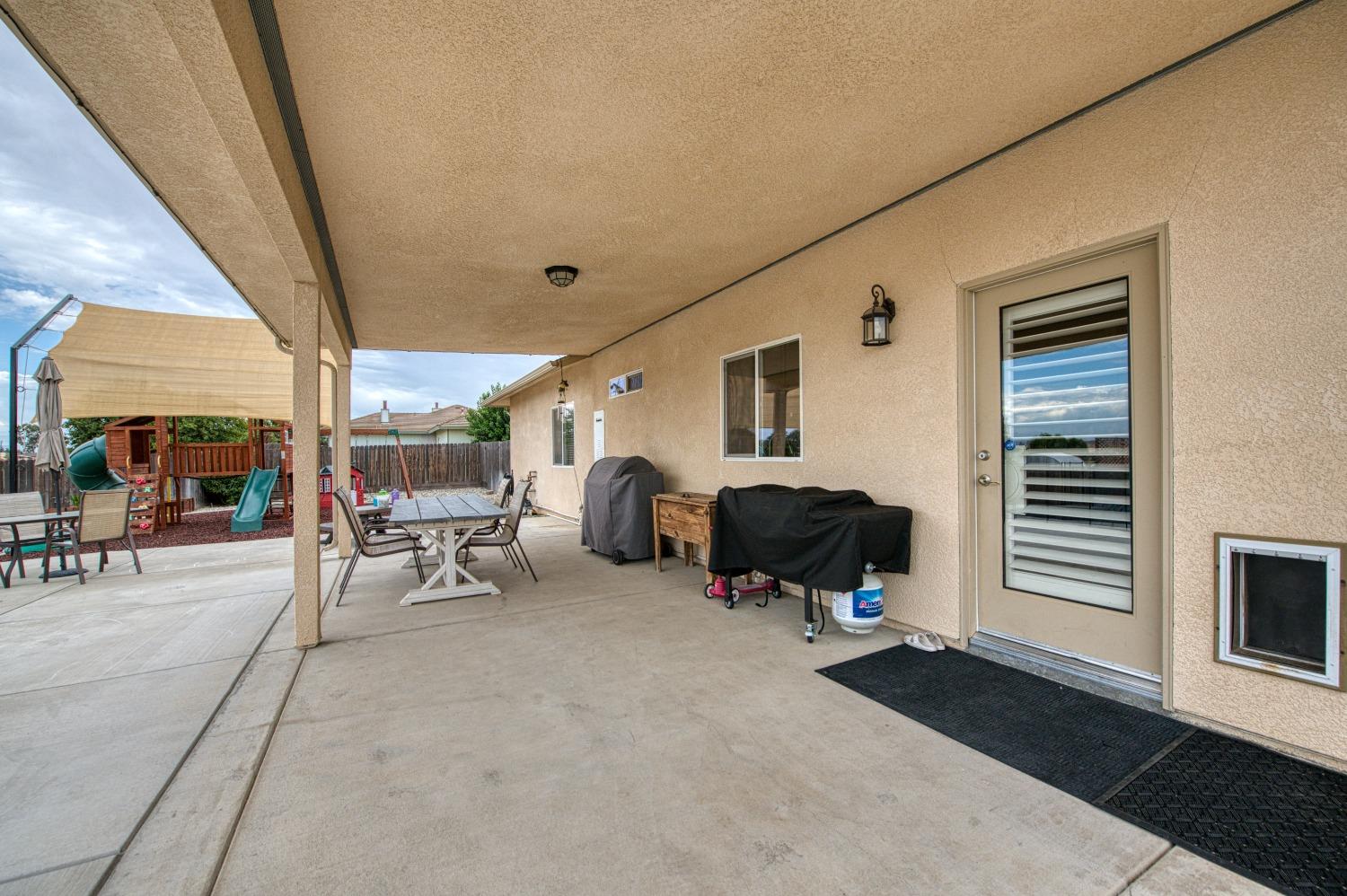 36919 Ave 17 1/2 Madera, CA 93636 - Photo 45 of 77 a living room with furniture and a window