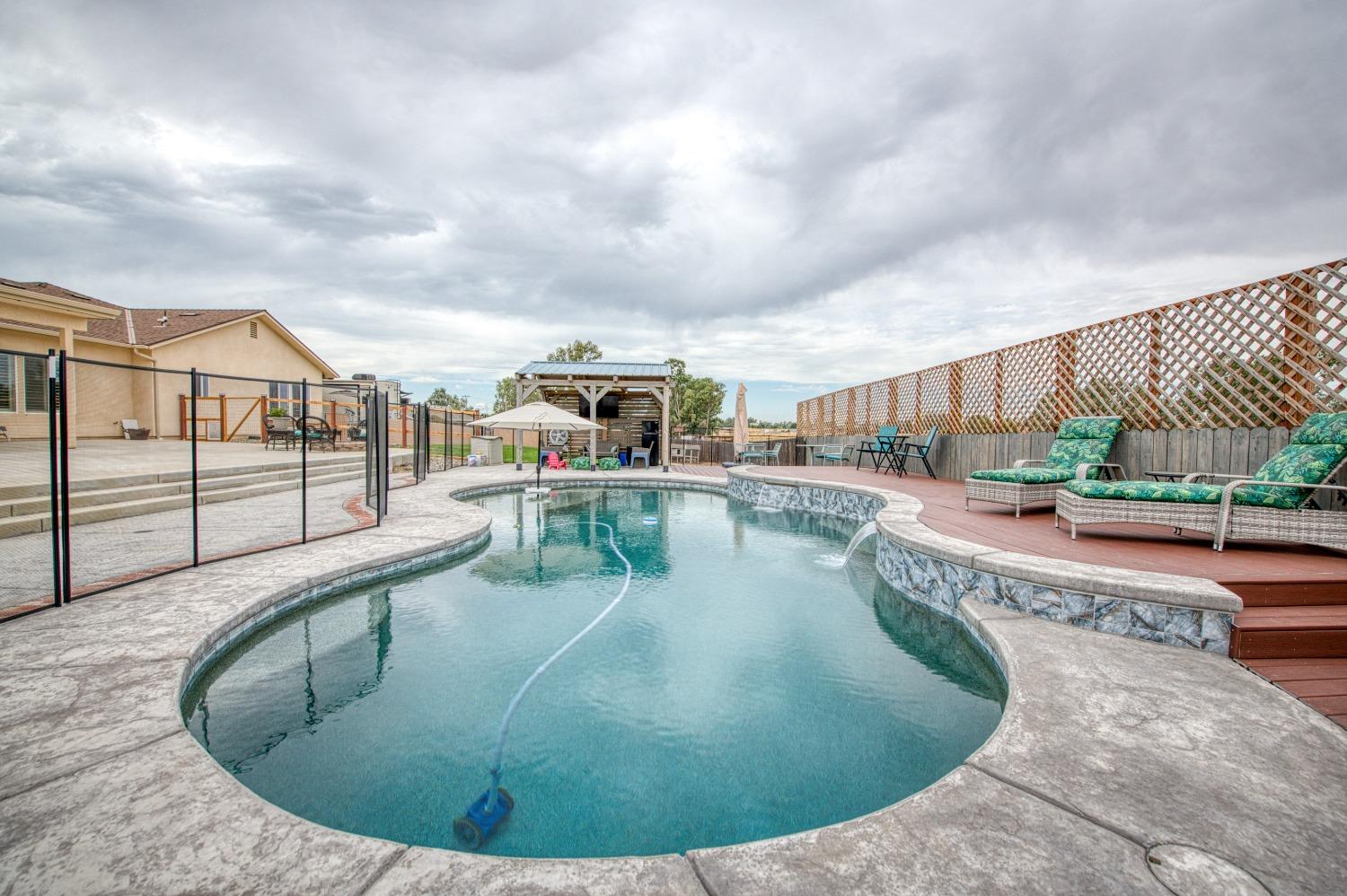 36919 Ave 17 1/2 Madera, CA 93636 - Photo 49 of 77 a view of a swimming pool with a patio