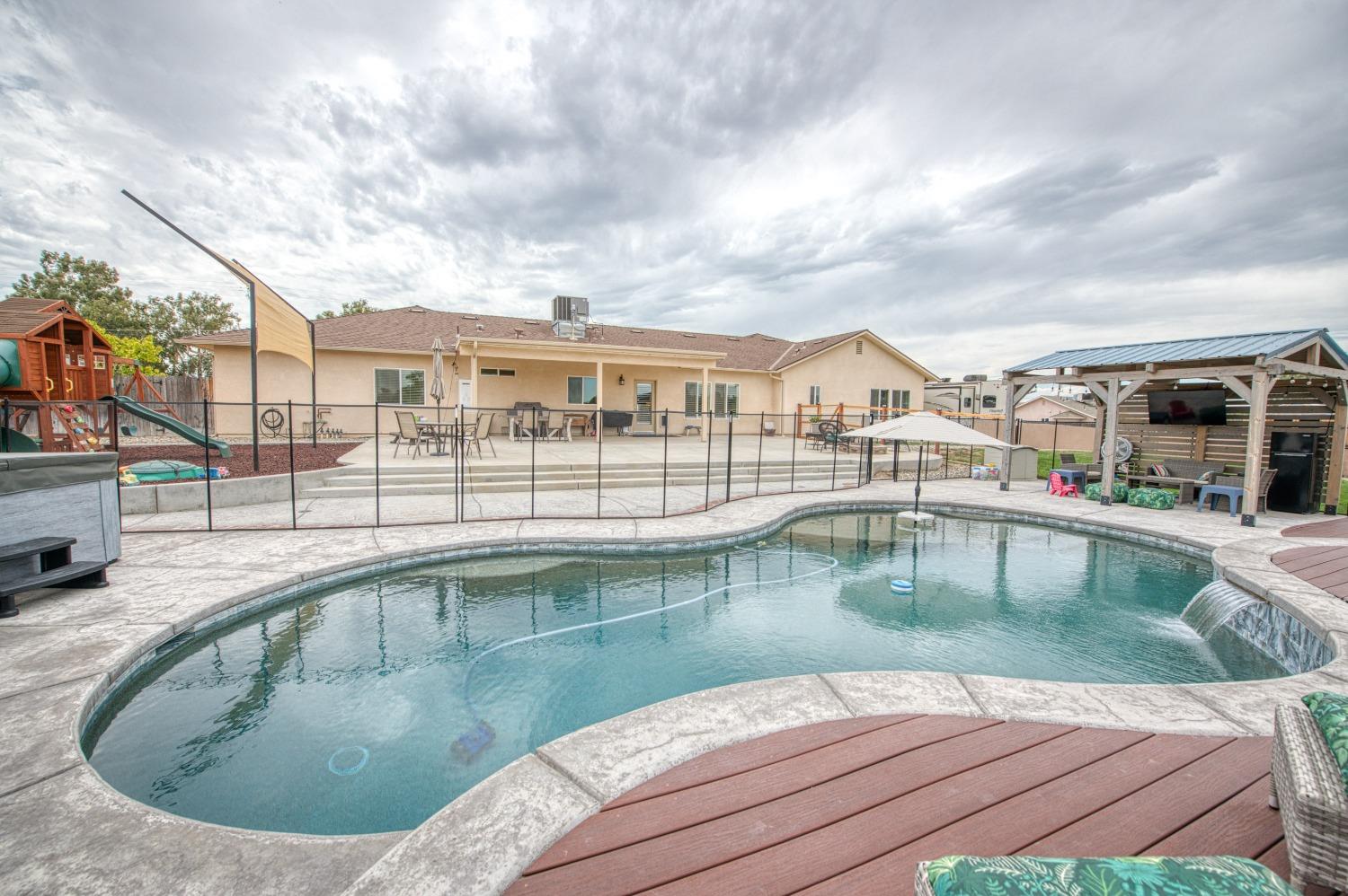 36919 Ave 17 1/2 Madera, CA 93636 - Photo 50 of 77 a view of a swimming pool with a lounge chairs