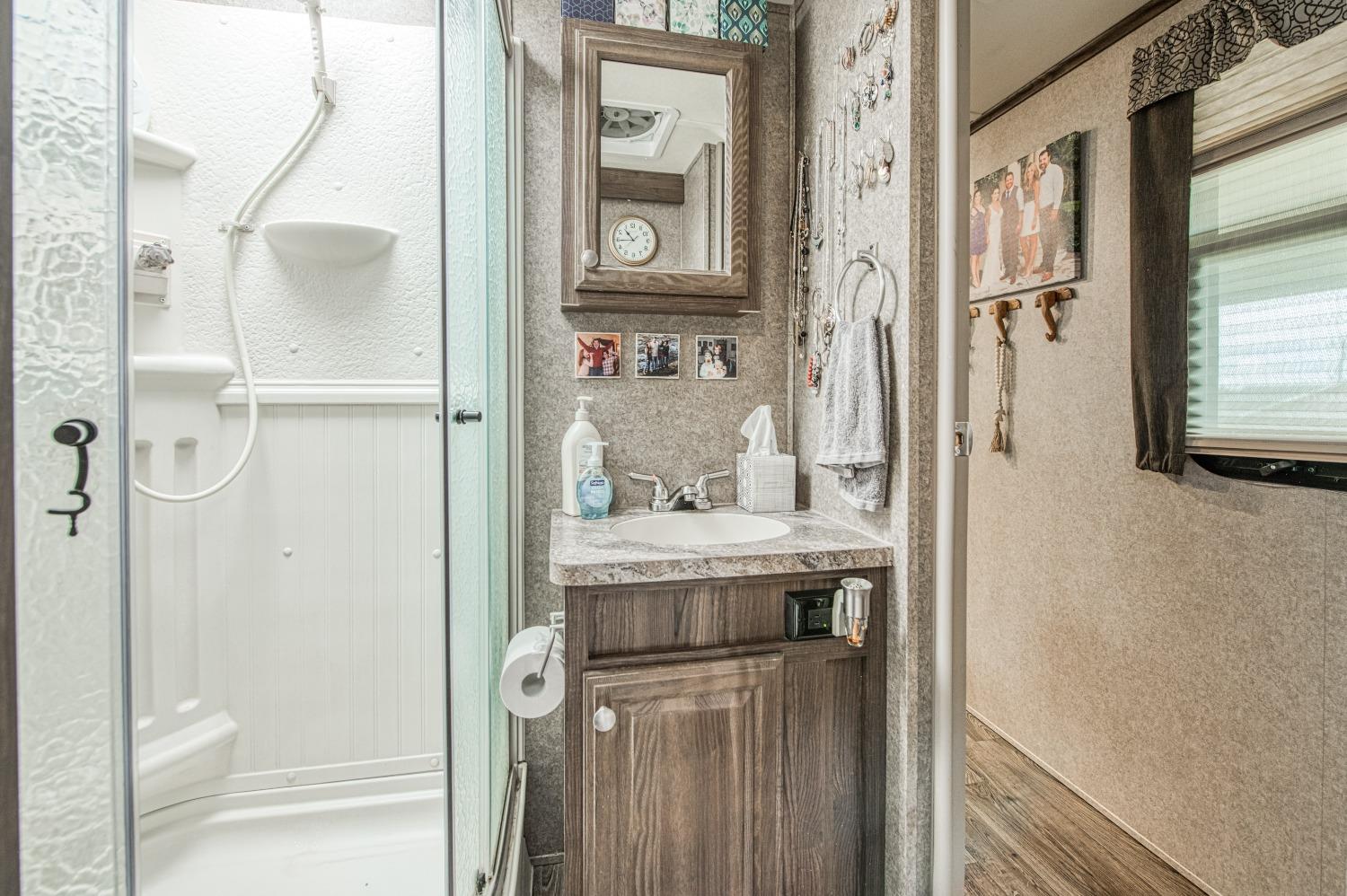 36919 Ave 17 1/2 Madera, CA 93636 - Photo 59 of 77 a bathroom with a granite countertop shower a mirror and a sink
