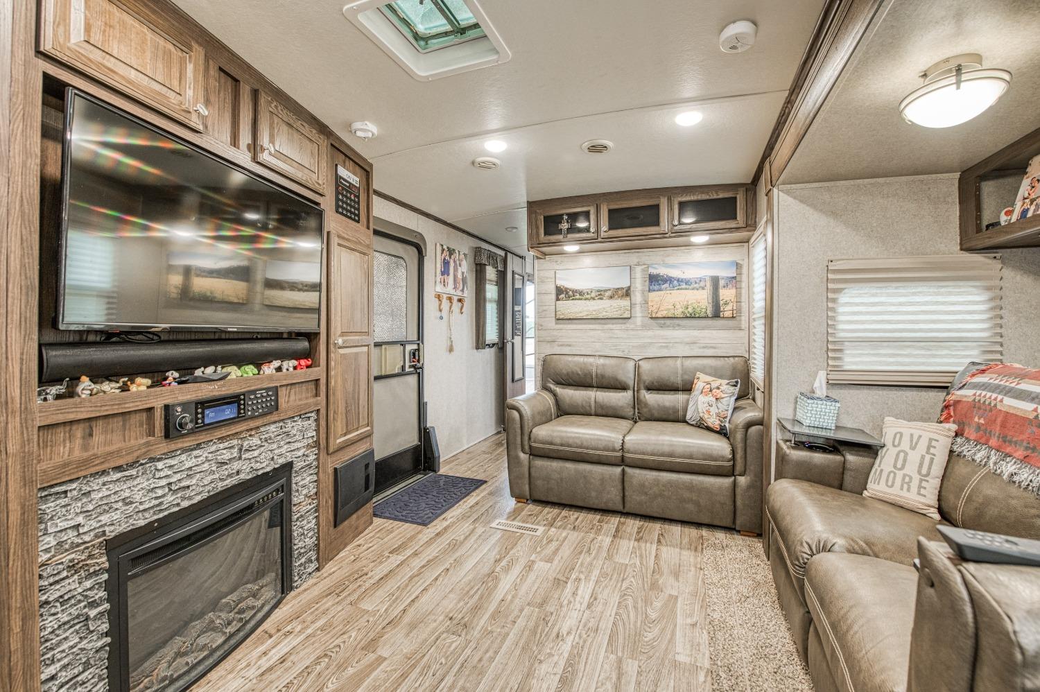 36919 Ave 17 1/2 Madera, CA 93636 - Photo 62 of 77 a living room with furniture and a flat screen tv