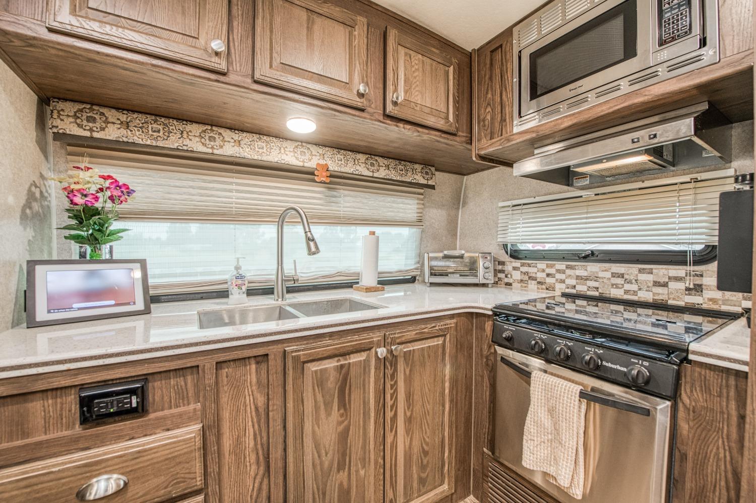 36919 Ave 17 1/2 Madera, CA 93636 - Photo 64 of 77 a kitchen with stainless steel appliances granite countertop a sink and a stove