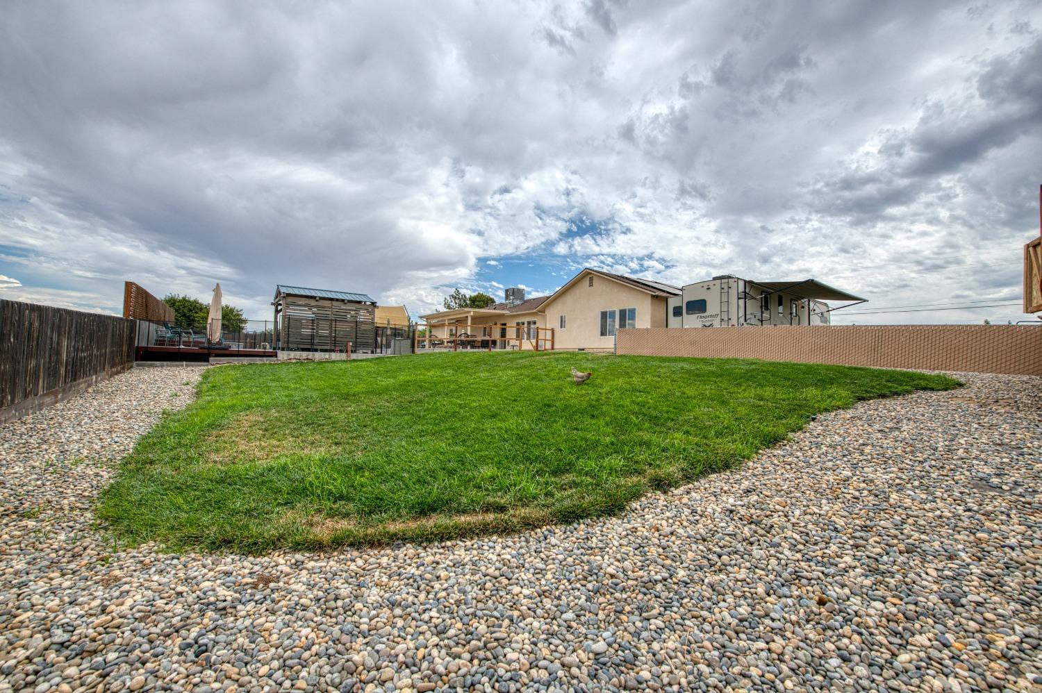 36919 Ave 17 1/2 Madera, CA 93636 - Photo 68 of 77 a view of a garden with house in the background