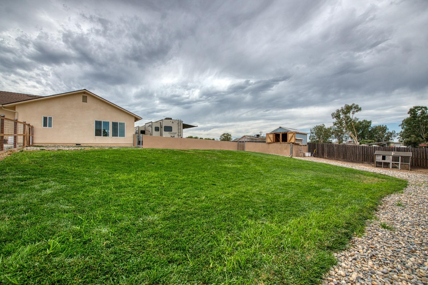 36919 Ave 17 1/2 Madera, CA 93636 - Photo 69 of 77 a view of a house with a big yard and a large tree