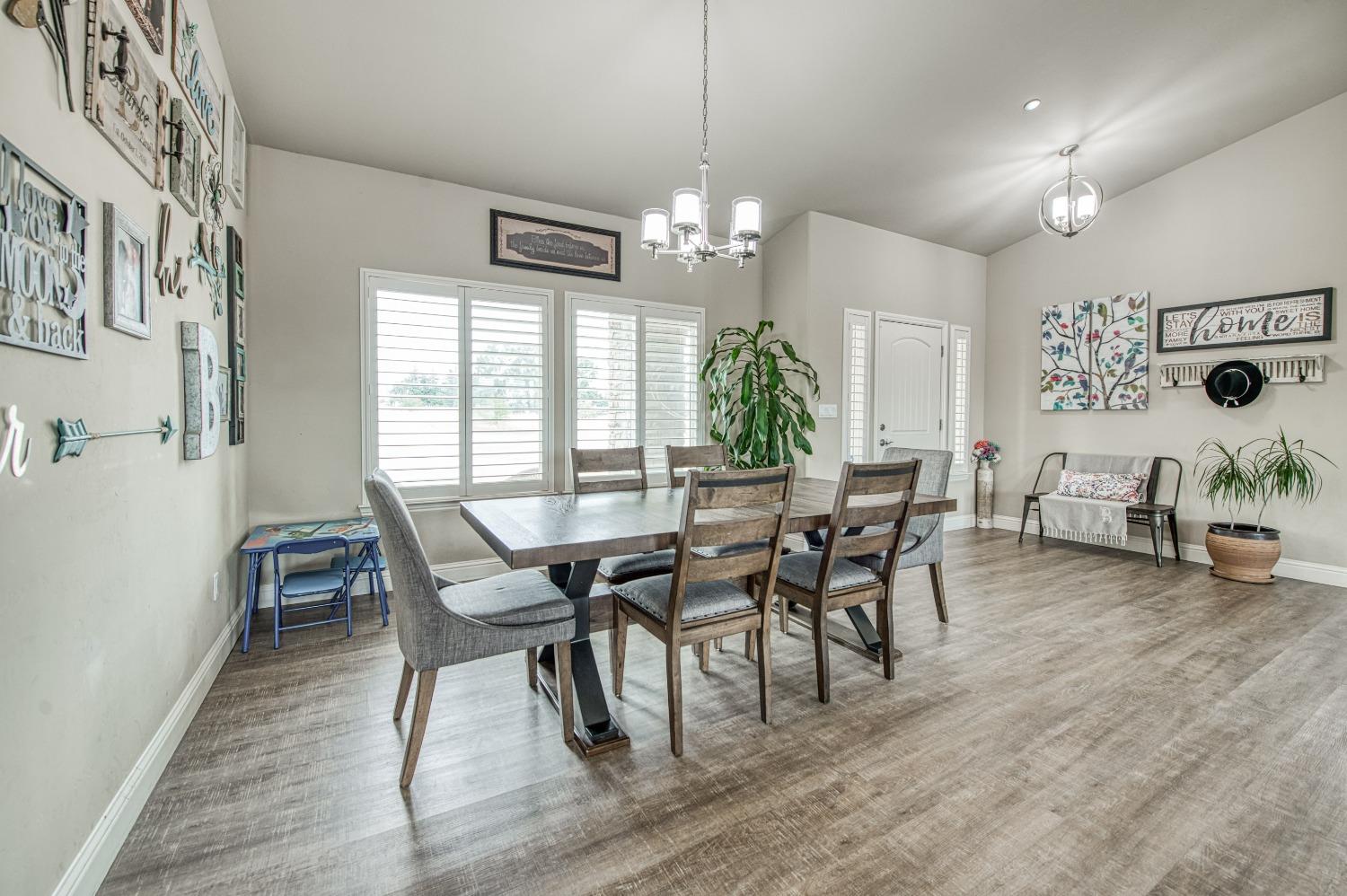 36919 Ave 17 1/2 Madera, CA 93636 - Photo 9 of 77 a view of a dining room with furniture window and wooden floor