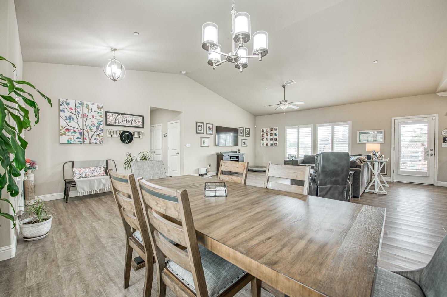 36919 Ave 17 1/2 Madera, CA 93636 - Photo 10 of 77 a view of a dining room with furniture and wooden floor