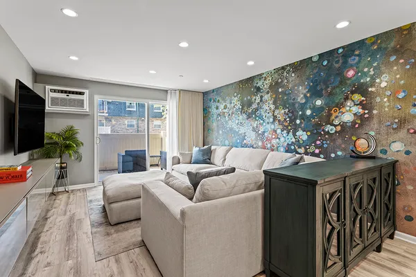 a living room with furniture and a chandelier