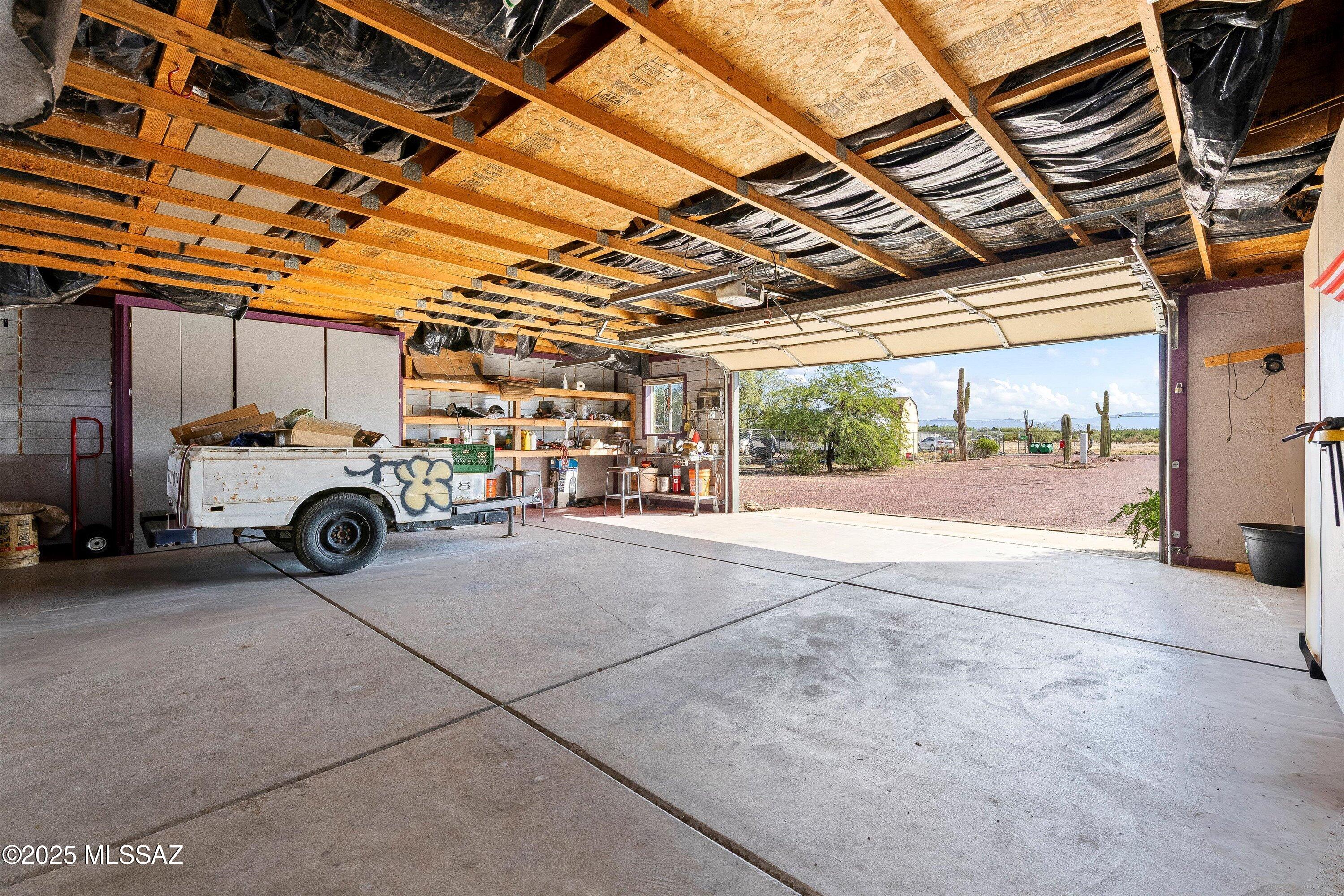 12055 North Musket Road Marana, AZ 85653 - Photo 3 of 17 Large 3 car garage with plenty of storage and workshop area.