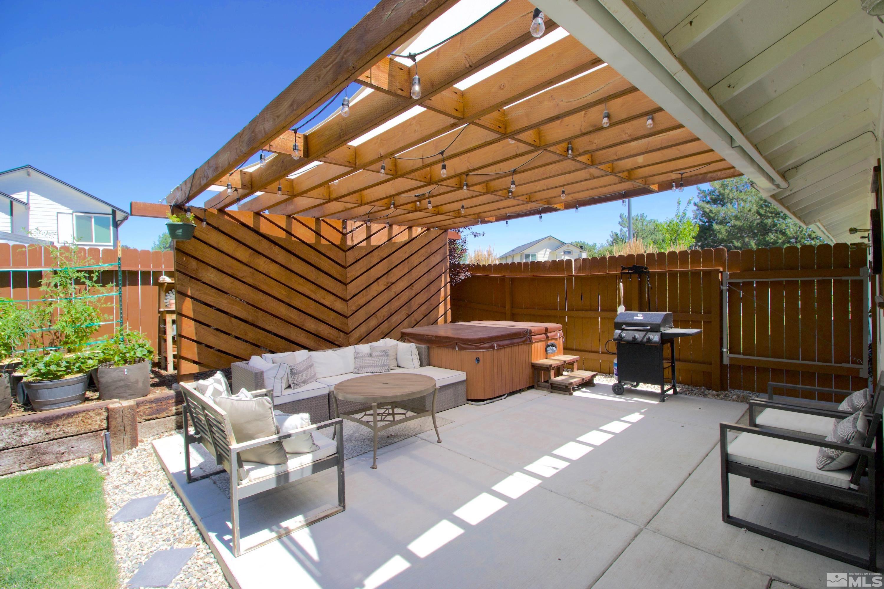 6350 Moon Ridge Terrace Reno, NV 89523 - Photo 2 of 19 a view of a patio with a table and chairs under an umbrella
