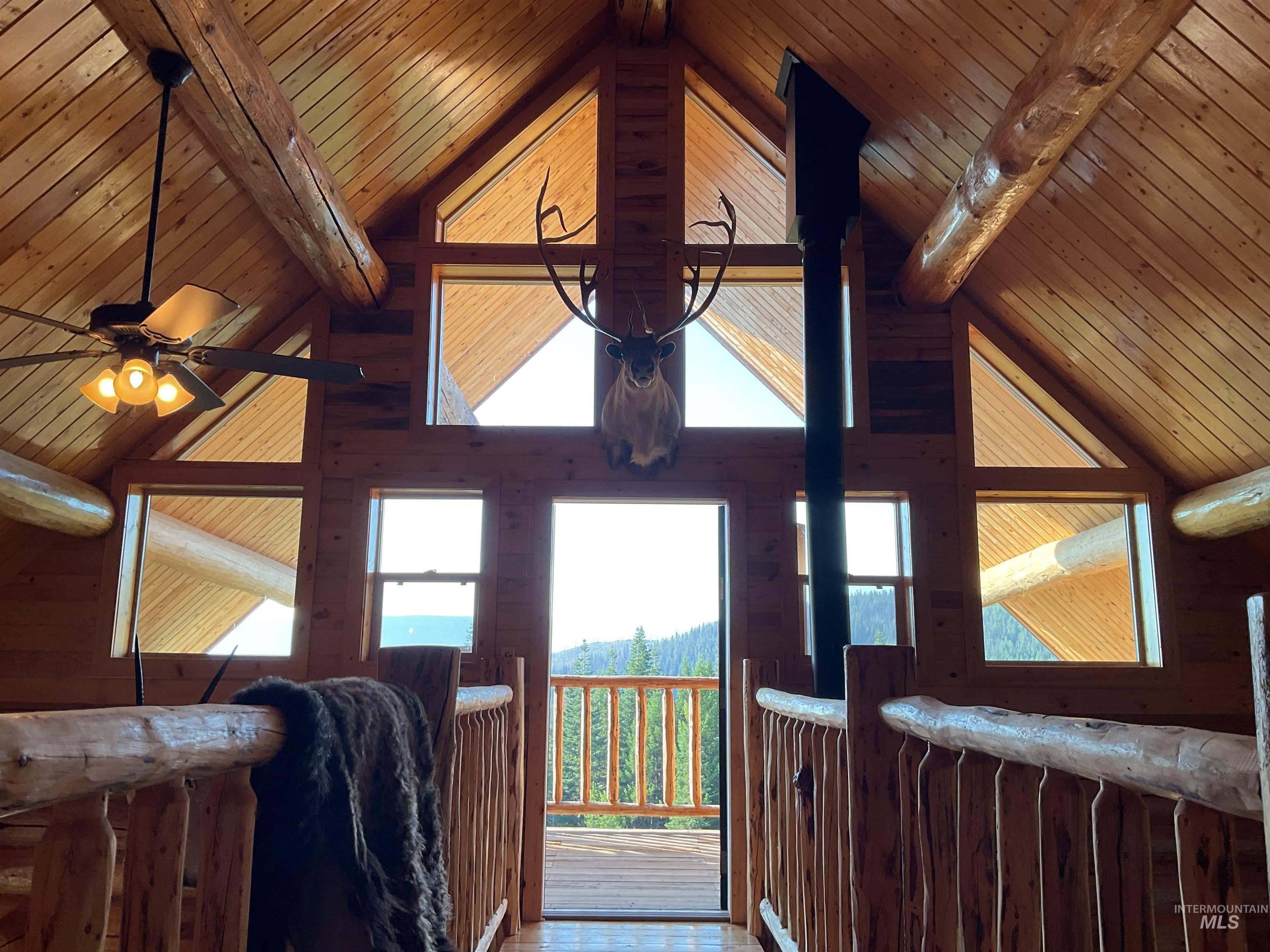625 Rhett Creek Road Elk City, ID 83525 - Photo 34 of 48 Custom log staircase with natural wood treads and log railing