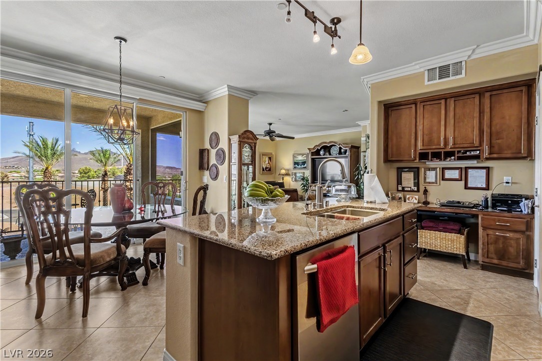 2555 Hampton Road, Unit 3308 Henderson, NV 89052 - Photo 13 of 65 Granite counters and rich cabinetry complement this open-concept kitchen, flowing into an adjacent dining area with outdoor views.