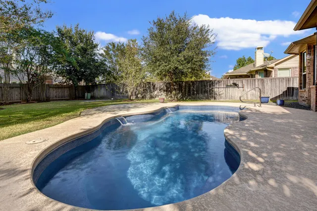 a view of swimming pool with wooden fence