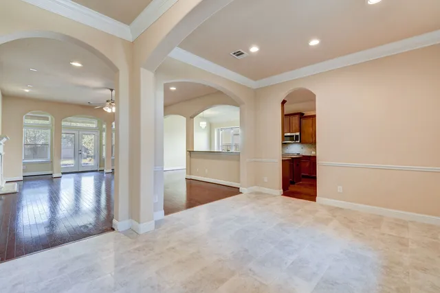 an empty room with closet and windows