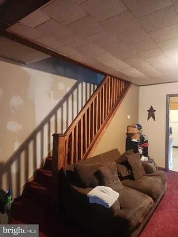 a living room with furniture and stairs