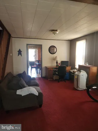 a living room with furniture rug and window
