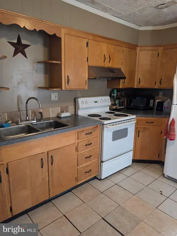 a kitchen with cabinets a sink and appliances