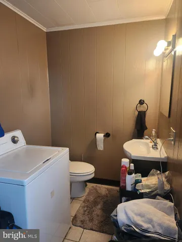 a bathroom with a sink toilet and a mirror