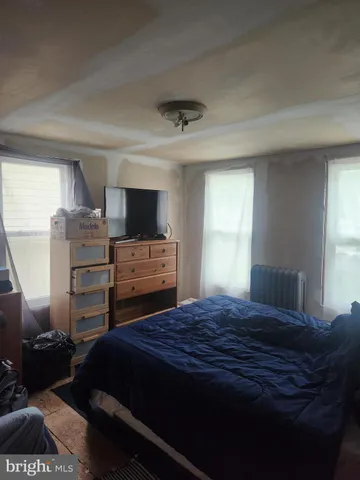 a bedroom with a bed and a television