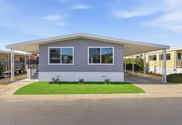 a view of a house with a backyard