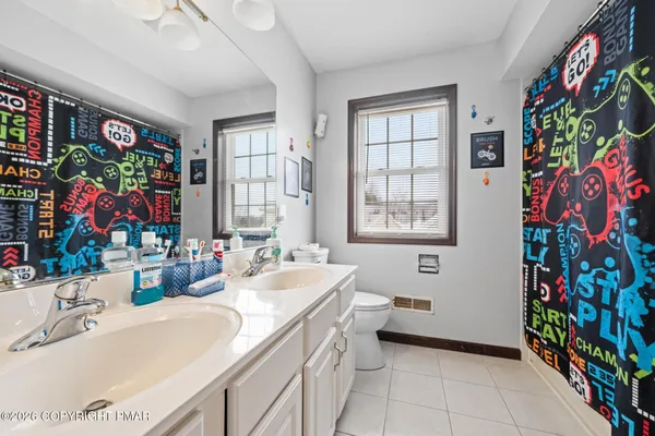 a bathroom with a sink a vanity and a large mirror