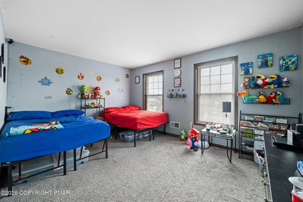 a living room with furniture and a dining table with bookshelf