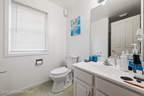 a bathroom with a sink a toilet and a mirror