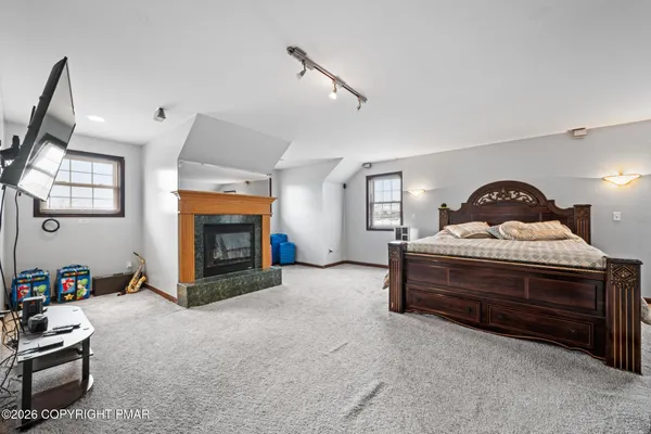 a bedroom with a bed and painting on the wall