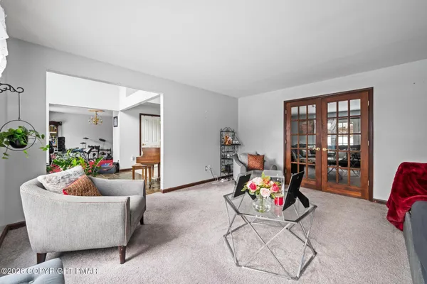 a living room with furniture and dining area