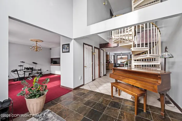 a lobby with furniture and flowers