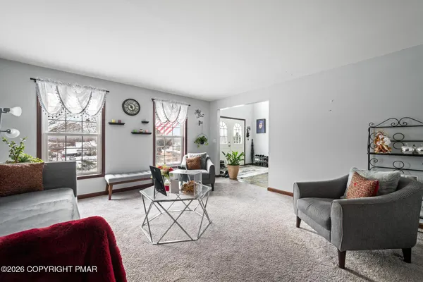 a living room with furniture a rug and a large window