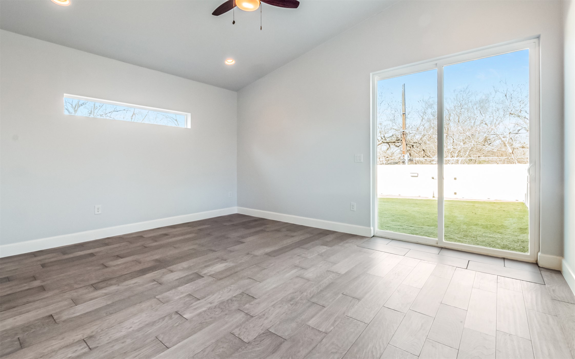 1130 Spur Street, Unit A Austin, TX 78721 - Photo 10 of 31 Unfurnished Primary Bedroom with access to the terrace, recessed lighting, and ceiling fan