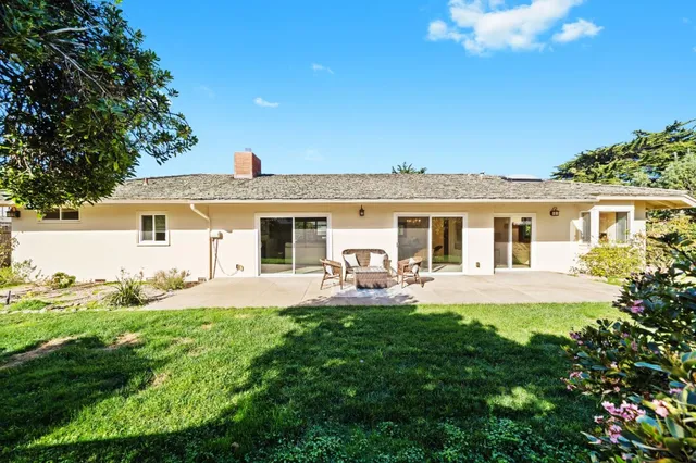 a front view of a house with patio and garden