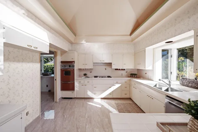 a kitchen with a sink stove and cabinets