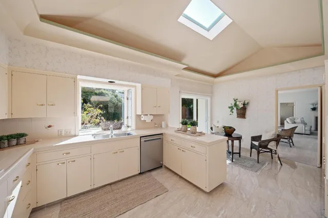 a view of a kitchen with center island and stainless steel appliances