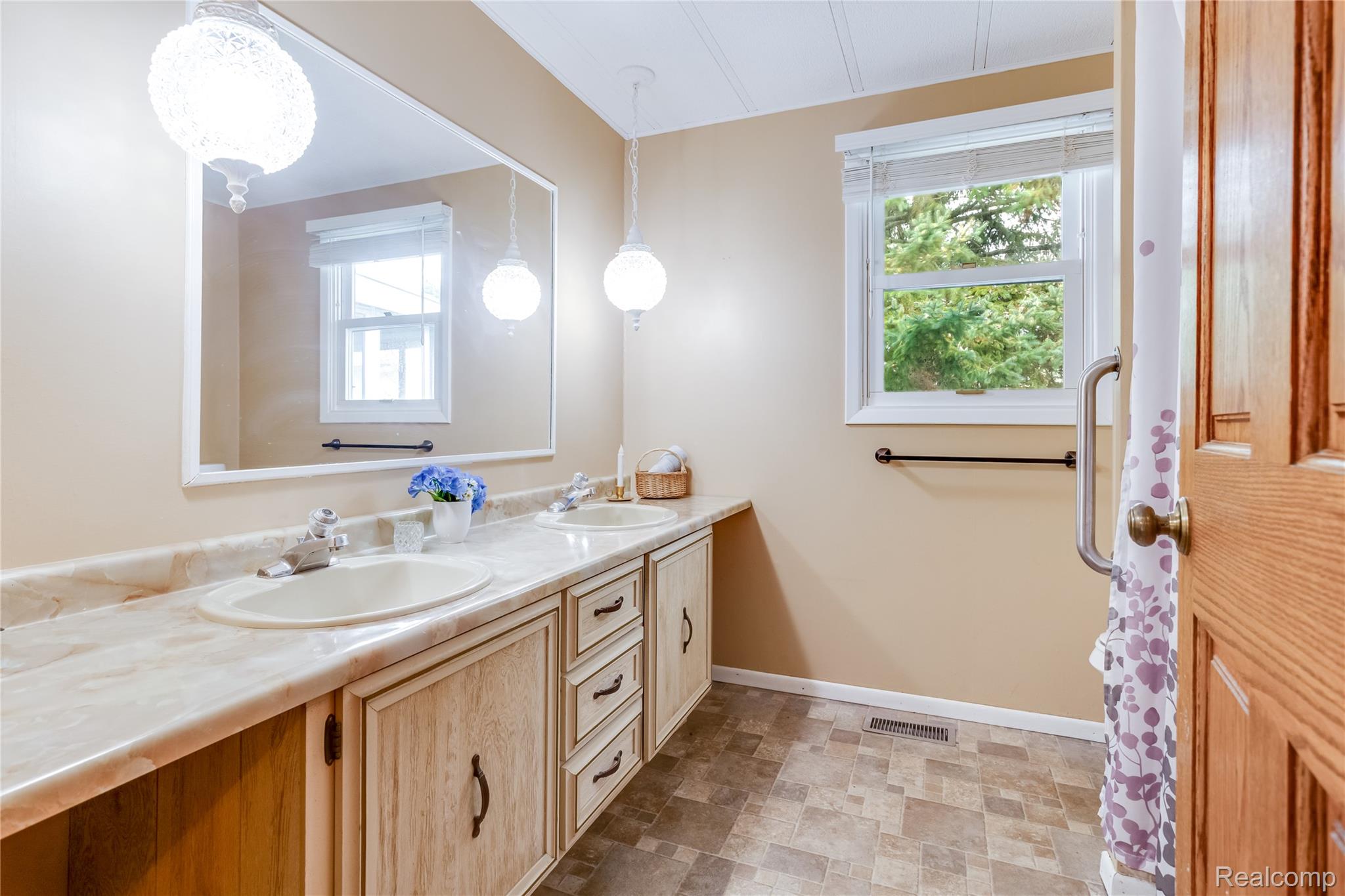 3333 Ravenswood Road Marysville, MI 48040 - Photo 12 of 25 Full bath featuring double vanity, stone finish flooring, and healthy amount of natural light