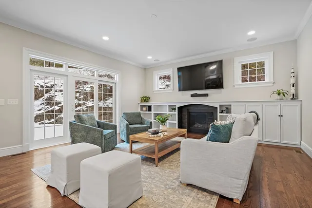 a living room with furniture a flat screen tv and a fireplace