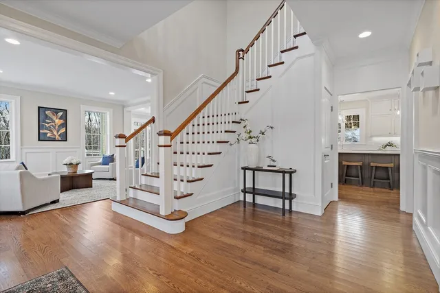 a view of entryway and hall with wooden floor