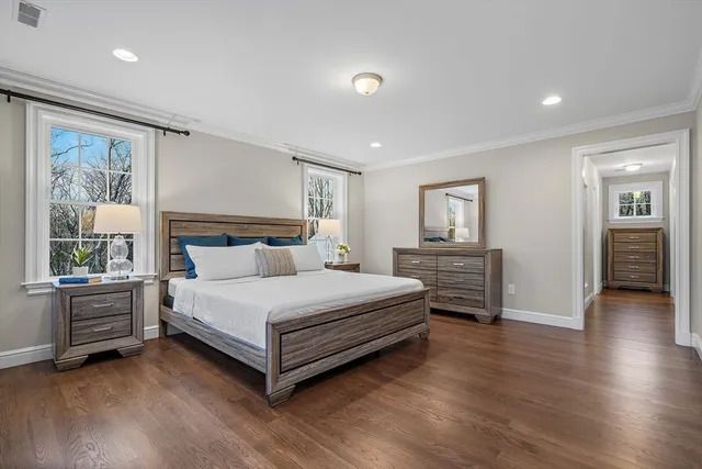 a bedroom with a bed and a large window