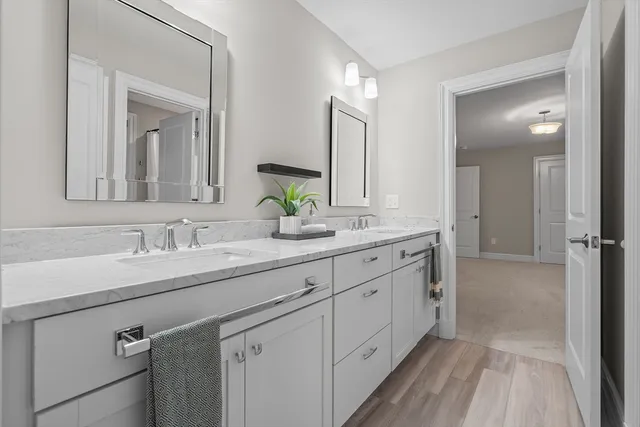 a bathroom with a double vanity sink and mirror
