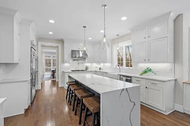 a kitchen with a table chairs refrigerator and cabinets